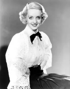 White Blouse Prints: Bette Davis, modeling a white batiste blouse with a black crepe slirt, 1935