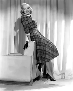 Grable Prints: Betty Grable in plaid, pleated sports dress, 1938