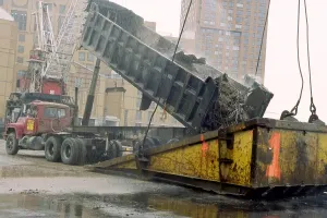 Images Dated 25th August 2011: A few blocks from Ground Zero a truck dumps World Trade Center debris into the bucket of a 500-ton crane at a Hudson