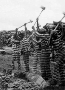 Negro Prints: The Blues. Negro convicts sing out while chopping a log with axes