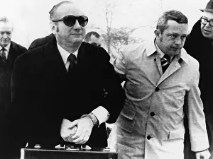 Candid Group Portrait Prints: Bobby Baker in hand cuffs is escorted by U
