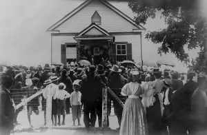 Orator Prints: Booker T. Washington addressing crowd from porch of a small building