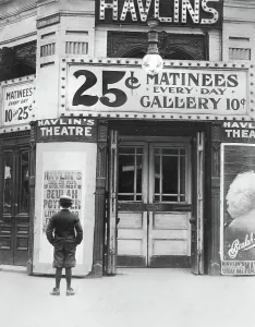 Shorts Prints: Boy in front of a movie theater showing a film with Beulah Poynter
