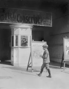 Shorts Prints: Boy in front of a movie theater showing THE GIRL CONSCRIPT