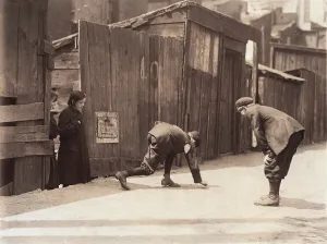 Picking Up Prints: Boys playing a dice game, from original caption: Red St