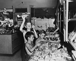 Toys Prints: Three boys playing with toys in a store, Greenbelt, Maryland. 1946. (BSLOC_2014_13_165)