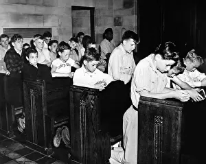 Nebraska Prints: Boys Town citizens bow their heads in prayer for the Father Flanagan