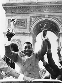 Brazilian Prints: Brazilian soccer star Pele waves the Jules Rimet Cup from an open car on Paris Champs Elysees
