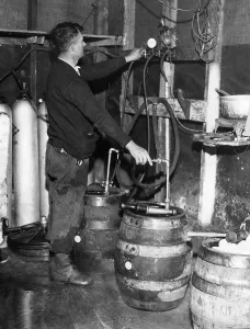 Prohibition Prints: A brewmeister fills kegs at a bootleg brewery during Prohibition