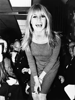 Brigitte Prints: Brigitte Bardot poses for newsmen after her arrival at JFK Airport in New York City