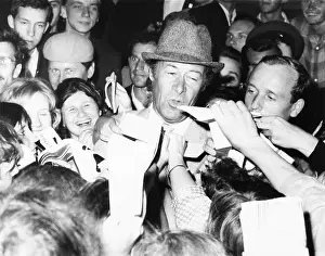 Excited Prints: British Actor Rex Harrison stepped into a swarm of Russian autograph seekers outside his hotel