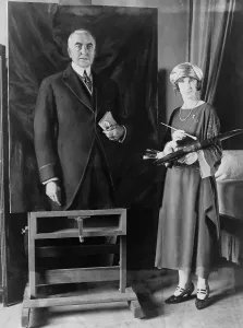 Images Dated 18th December 2007: British artist, Margaret Lindsay Williams (1887-1960) stands beside her portrait of President Warren Harding
