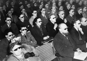 Theaters Prints: British audience wears smoke-colored glasses to view a 3-D movie in 1954