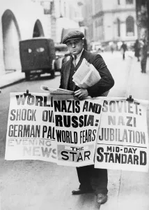 Rs4wn Prints: British man holding newspapers and large signs announcing Nazi German- Soviet Russian non-aggression pact
