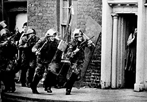 Soldier Prints: British soldiers chase a sniper down the street in Northern Ireland while a British housewife stands shocked in a