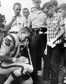 Congressman Prints: Buffalo Bills player Jack Kemp signs his autograph for a boy on August 4