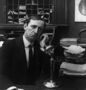 Offices Prints: Businessman on telephone with disappointed look. 1906