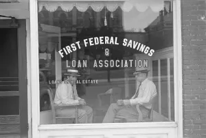 Real Estate Prints: Two businessmen sit behind the storefront window of a Marion