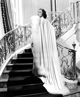 Evening Coat Prints: CAFE METROPOLE, Loretta Young, in a white crepe dress with a fox-fur trimmed coat by Royer