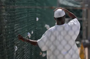 Ethnic Clothing Prints: In Camp Delta prison at Guantanamo Bay Naval Base Cuba a detainee stands in the recreation yard