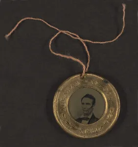 Button Prints: Campaign button for 1860 presidential election showing bust tintype portrait of Abraham Lincoln in a metal casing