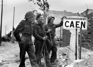 Canadians Prints: Canadian soldiers at a sign for the port city of Caen
