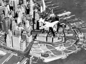 Financial District Prints: Captain Frank Hawks new Speed Plane flying over Manhattan's financial district and Battery Park