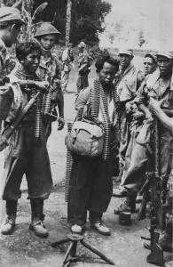 Ammunition Prints: Two captured Indonesian army soldiers, with bandoliers around their necks, 1947