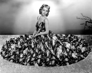 Landis Prints: Carole Landis modeling seersucker evening gown in seafoam with accents of pique 1940