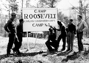 Government Agency Prints: CCC (Civilian Conservation Corps) members erect sign for their Camp Roosevelt