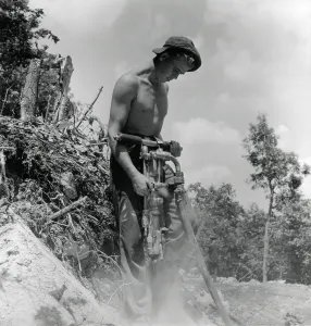 Images Dated 10th June 2013: CCC enrollee drilling holes for dynamite shots