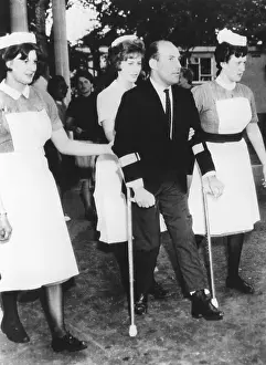 Racer Prints: Champion racing driver Sterling Moss on crutches at a British hospital, on June 22, 1962