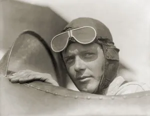Lindbergh Prints: Charles Lindbergh 1902-1974 wearing a helmet with goggles up in open cockpit of airplane at Lambert Field St