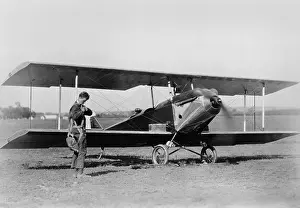 Propeller Prints: Charles Lindbergh, adjusting parachute before testing an experimental plane, c. 1925