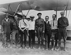 Flyers Prints: Charles Lindbergh with seven other men, in front of biplane, Lambert-St. Louis Field, 1923