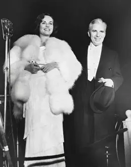 Movie Stars Prints: Charlie Chaplin attends the premiere of MODERN TIMES with his leading lady