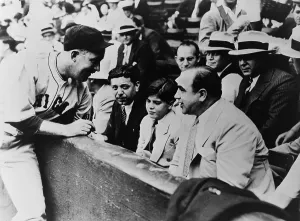 Mobster Prints: Chicago Cubs player Gabby Hartnett autographing a baseball for Sonny Capone who is sitting with his father Al Capone