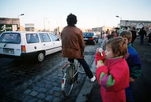 Communism Prints: A child blows bubbles as carsfreely cross the border of East and West Berlin at Potsdamer Platz