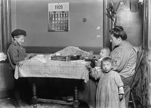 Calendar Prints: Child labor, Widow & boy rolling papers for cigarettes in a dirty tenement