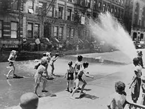 Bathing Suits Prints: Children escape the heat of the East Side by opening a fire hydrant