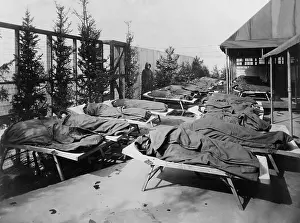 Chicago Prints: Children lie on cots, wrapped in blankets