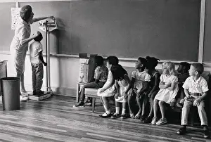 Height Prints: Children of migrant workers being measured for height
