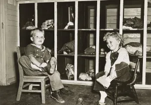 Nursery Prints: Children take off their shoes before a nap in a public nursery during World War 2