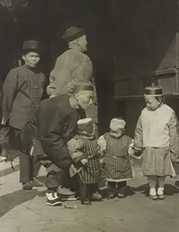 Sidewalk Prints: Chinese American men and three children in traditional dress standing on a street in San Francisco