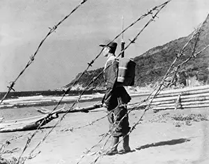 Rs4wn Prints: Chinese Nationalist soldier stands guard on a sandy beach somewhere along Formosa's coast