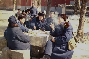 November Prints: Chinese people in coats and warm hats have lunch outdoors in Beijing during Nixon's visit to China