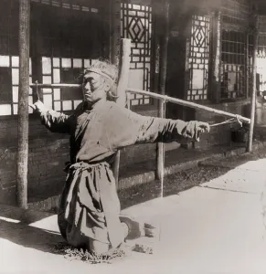 Convict Prints: Chinese prisoner kneeling on chains