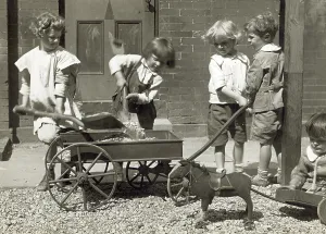 Edwardian Prints: Chrildren playing with rocks, a wagon and a toy pony