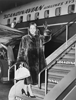 Christine Prints: Christine Jorgensen, waves as she boards an airplane, at Copenhagen, Denmark, in Feb. 1953