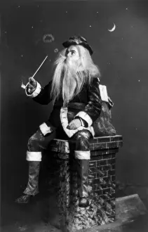Santa Claus Prints: Christmas, caught in the act, Santa Claus seated on model of chimney smoking long pipe and blowing circles of smoke